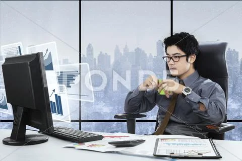 Asian businessman with coffee and virtual graph Stock Photos