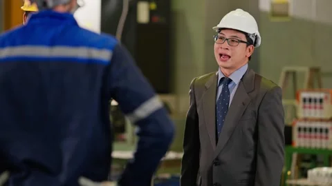 Asian Businessman in Hardhat Talking to Engineer in Modern Factory. Stock Footage 343428894