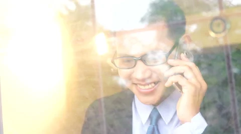 Asian businessman in office talking calling on cellphone Stock Footage 68853353
