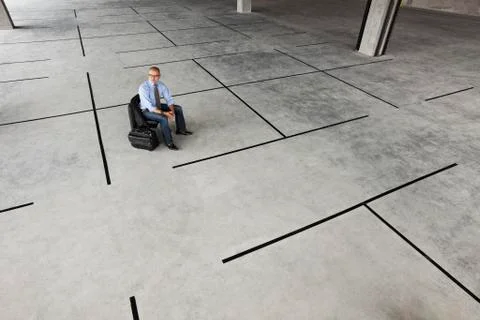 Asian businessman taking a look at a large empty raw office space. Stockfoto's