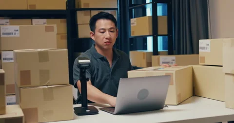 Asian businessman use barcode machine scan customer data in paper box. Stock Footage 202127116