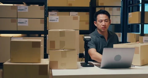Asian businessman use barcode machine scan customer data in paper box. Stock Footage 202131689