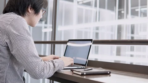 Asian businessman using laptop computer and smartphone on desk Stock-Footage 91069372