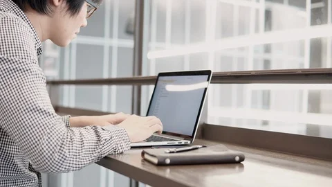 Asian businessman using laptop computer in working space Stock Footage 91083987
