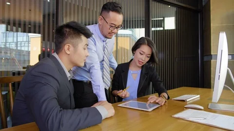 Asian Businesspeople Using Tablet Stock Footage 106223354