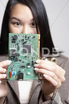 Asian Businesswoman Holding Up Computer Circuit Board