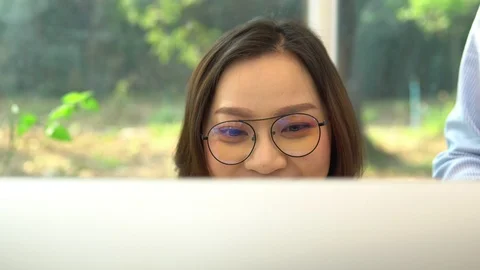 An Asian businesswoman working in front of a computer monitor  Stock Footage