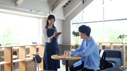 Asian Cafe Staff Taking Order from Male Customer at Table Stock Footage 344092317