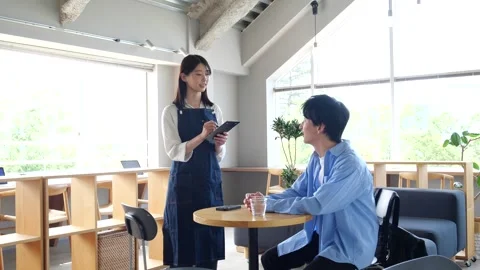 Asian Cafe Staff Taking Order from Male Customer at Table Stock-Footage 344092346