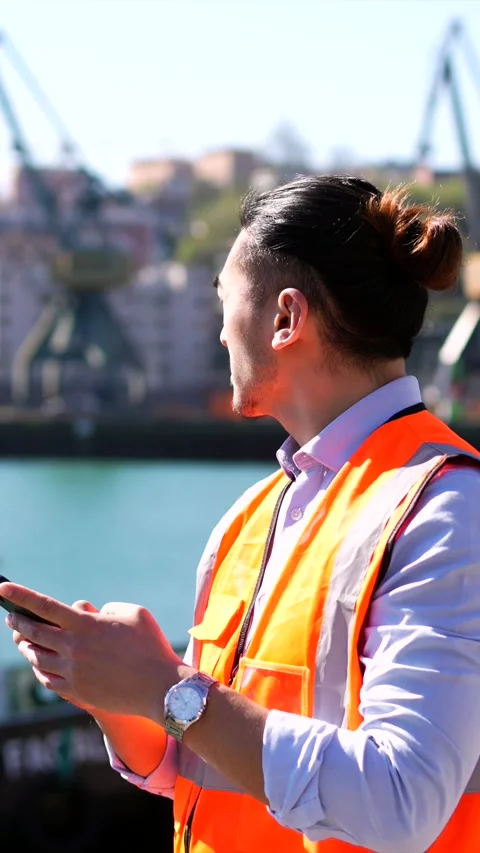 Asian cargo port worker using smartphone Stock Footage 333731552