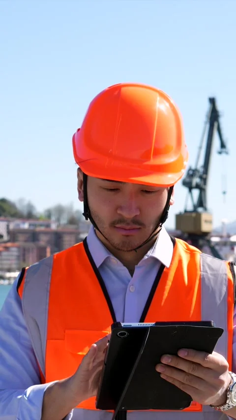 Asian cargo port worker using a tablet for logistics management Stock Footage 333731608