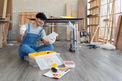 Asian carpenter inspect the list of items that must be done as scheduled Stock Photos