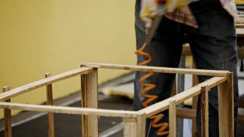 Asian carpenter worker wearing protective gloves is using power drill assembling Stock Footage 229068604