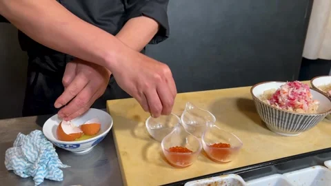 Asian Chef in Black Uniform Cracking Egg for Japanese Dish 库存影片 327710224