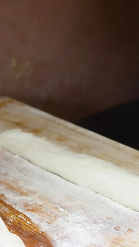 Asian Chef Brushing and Cutting Bread Dough on Wooden Table 库存影片 341302880