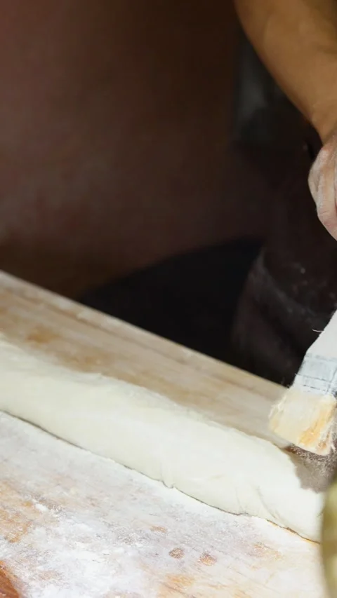 Asian Chef Brushing Flour and Cutting Dough on Wooden Table Video stock 340966552
