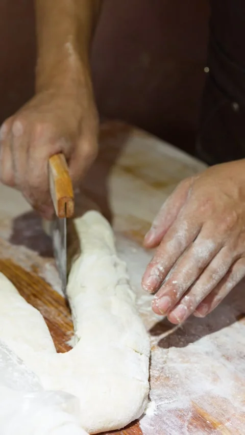 Asian Chef Cutting Bread Dough with Bench Scraper on Wooden Counter 库存影片 341395533