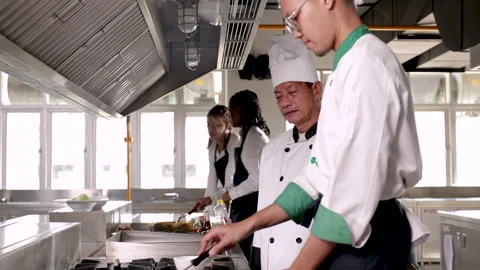Asian chef trainee in chef uniform or student show hot Asian food cooking i.. Stock Footage 245140332