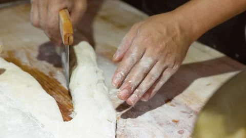Asian Chef Using Bench Scraper to Cut Bread Dough 库存影片 341068171