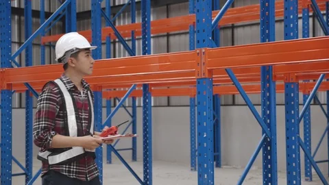 Asian Chief Engineer or contractors talking about work in factory or warehouses Stock Footage 130068327