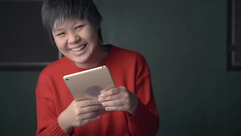 Asian child is autistic looking tablet computer for learning, autism girl wat Stock Footage 152306199