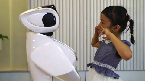 Asian child extends a hand to the robot Stock Footage 148003747