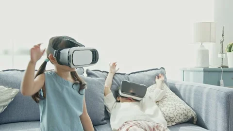 Asian child feeling excited while using 360 VR headset for virtual reality, M Stock Footage 194542206