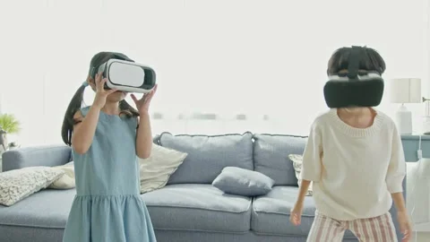 Asian child feeling excited while using 360 VR headset for virtual reality, M Stock Footage 194813628