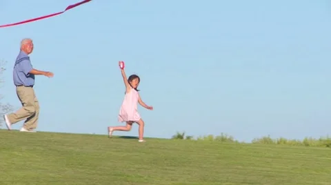 Asian Child Flying Kite with Grandfather Stock Footage