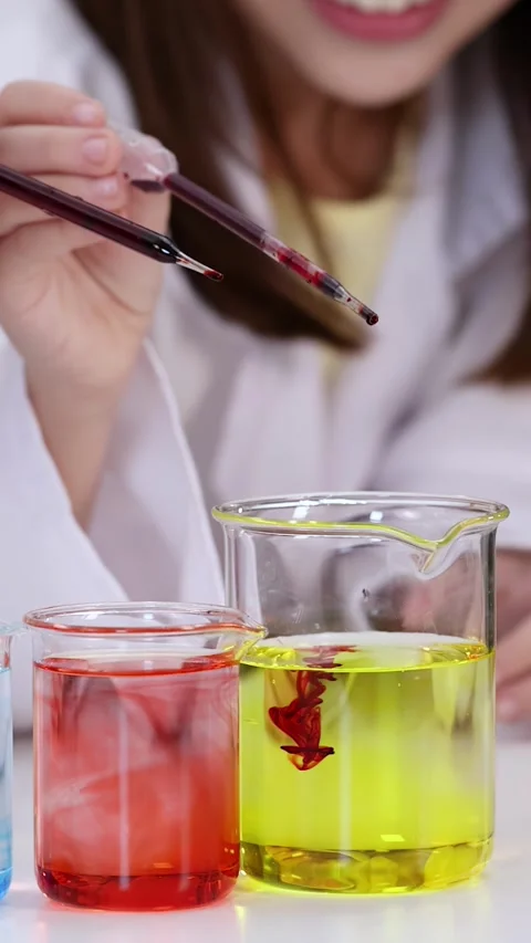 Asian Child in Lab Coat Dropping Liquid into Science Beaker Stock Footage 340135498