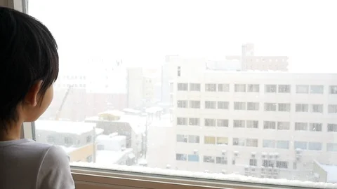 Asian child looking at the window slow motion Stock Footage 91445702