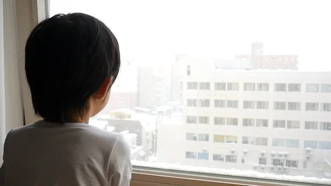 Asian child looking at the window slow motion Stock Footage 91446336