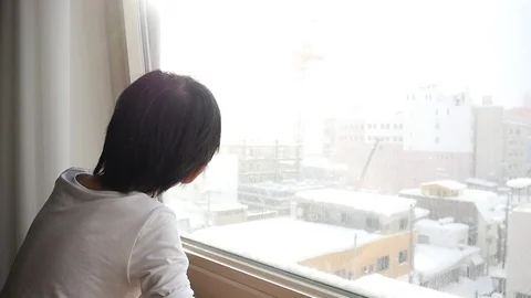 Asian child looking at the window slow motion Stock Footage 91530865