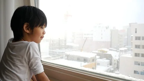 Asian child looking at the window slow motion Stock Footage 91531493