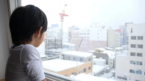 Asian child looking at the window slow motion Stock Footage 91535528