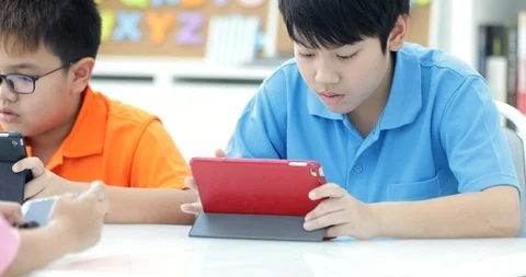 Asian child playing tablet computer together Stock Footage 89768862