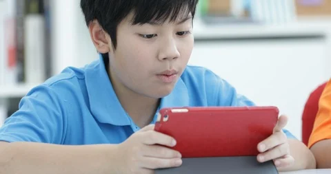 Asian child playing tablet computer together Stock Footage 89768916