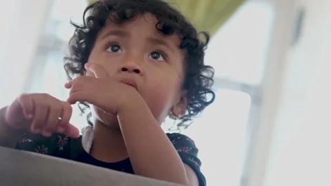 Asian children with cute expression, curly hair at home slow motion video Stock Footage 201408445