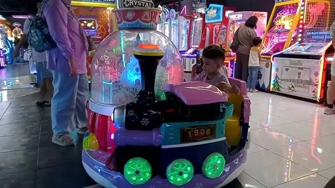 Asian children is have fun while riding snow globe carousel Vídeo Stock 336629905