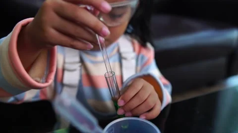 Asian children having fun doing liquid science lab experiments Stock Footage 221178973