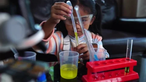 Asian children having fun doing liquid science lab experiments 動画素材 221178995
