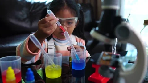 Asian children having fun doing liquid science lab experiments Stock Footage 221179019