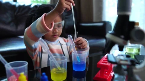 Asian children having fun doing liquid science lab experiments Stock Footage 221179026