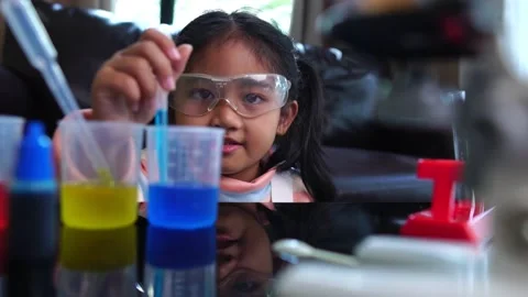 Asian children having fun doing liquid science lab experiments Stock Footage 221179078
