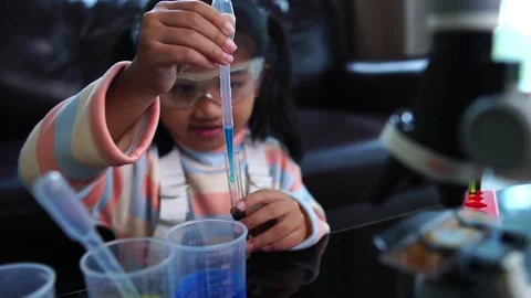 Asian children having fun doing liquid science lab experiments Stockbeeldmateriaal 221179180