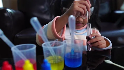Asian children having fun doing liquid science lab experiments Stock Footage 221179379
