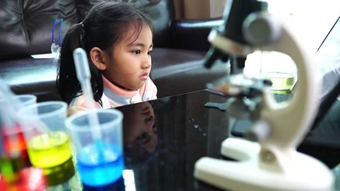 Asian children having fun doing liquid science lab experiments Stockbeeldmateriaal 221179566