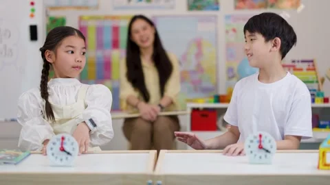 Asian Children Learning to Tell Time in Classroom Activity Stock Footage 330101912