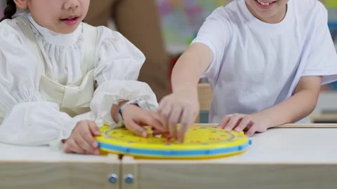 Asian Children Learning to Tell Time With Clock Toy Stock Footage 330102154