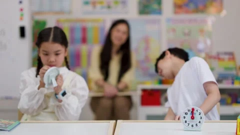 Asian Children Learning to Tell Time in Classroom Activity Stock Footage 330102225